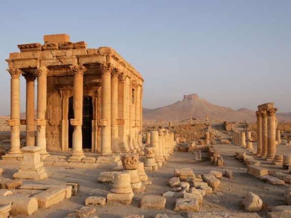The Baalshamin sanctuary, located in the north of the city of Palmyra. Its construction began in the second century BC. Gradually was added a colonnaded courtyard after 67 AD and a cella in 130 AD; Citadel in the distance, Palmyra. Syria Picture by Manuel Cohen