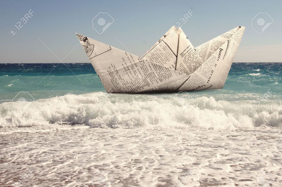 paper boat floating in a sea